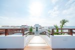 The Casa del Mar community rooftop with pool, oceanview, beds, and lounge chairs